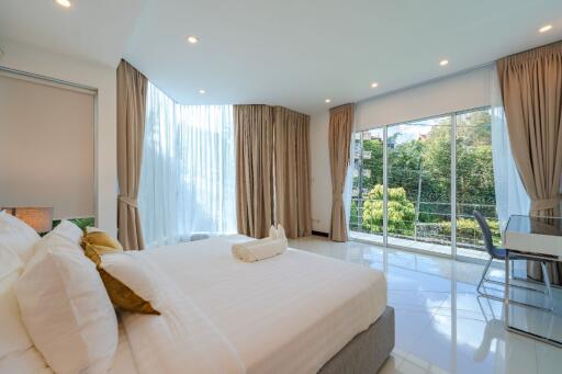 Bright and spacious bedroom with large windows