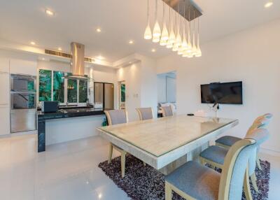Modern dining area with kitchen in background
