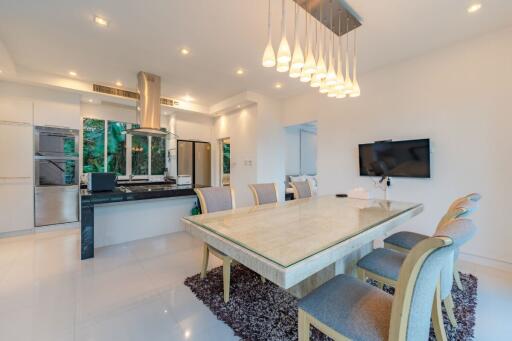 Modern dining area with kitchen in background