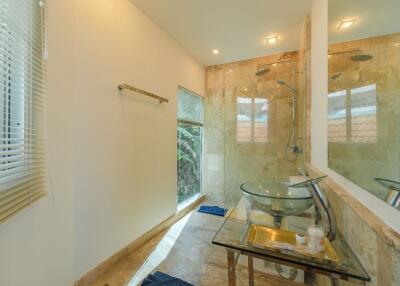 Modern bathroom with glass sink and rainfall shower