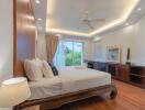 Spacious bedroom with double bed, large window, and wooden flooring