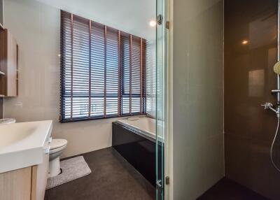 Modern bathroom with a large window, bathtub, and shower