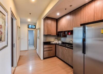 Modern kitchen with wooden cabinets and stainless steel appliances