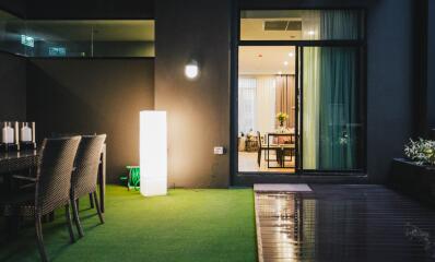 Outdoor patio with view into brightly lit interior