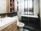 Modern bathroom with glass shower door and wooden cabinets