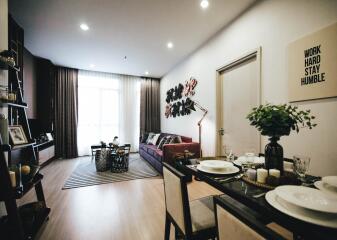 Modern living room with dining area, elegant decor, and natural light