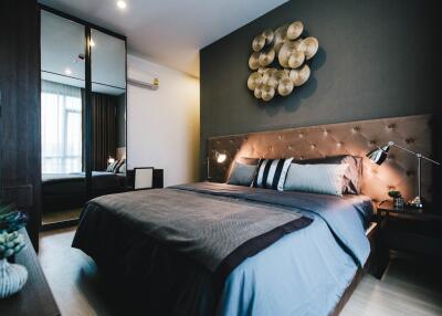 Modern bedroom with decorative wall art and bedside lamps