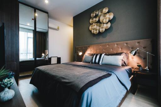 Modern bedroom with decorative wall art and bedside lamps