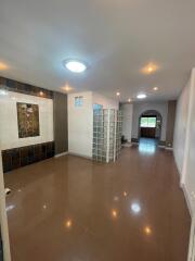 Spacious modern living area with tiled floor, recessed lighting, and decorative wall elements