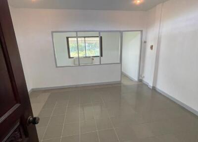 Spacious bedroom with tiled flooring and a large window