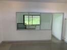 Empty room with large window and interior glass partition