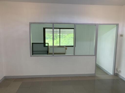 Empty room with large window and interior glass partition