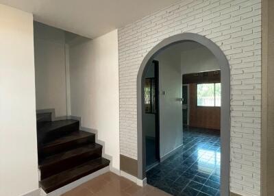 Entryway with stairs and arched doorway