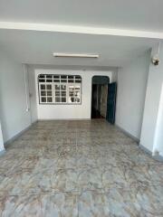 Empty living room with tiled floor and large window