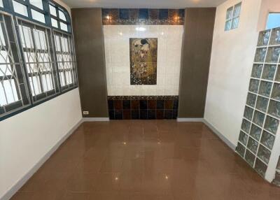 Living area with tiled flooring and wall accent