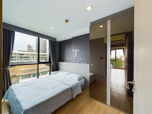 modern bedroom with large windows and city view