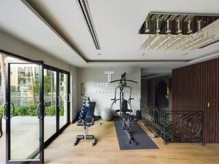 Home gym with exercise equipment and glass doors to the outside