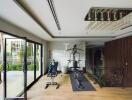 Home gym with exercise equipment and glass doors to the outside