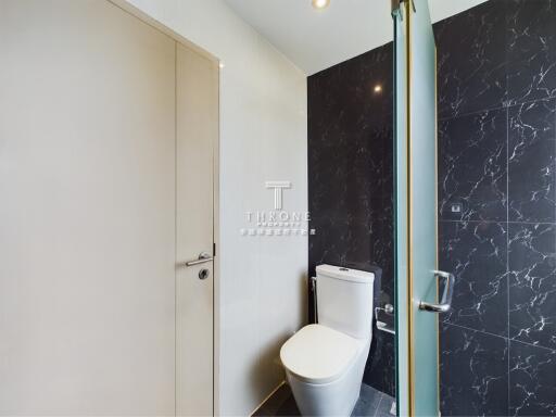 Modern bathroom with marble wall and white toilet