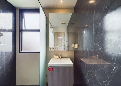 Modern bathroom with marble tiles and glass shower