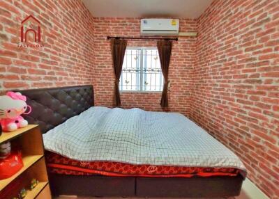 Cozy bedroom with brick walls