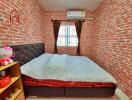 Cozy bedroom with brick walls