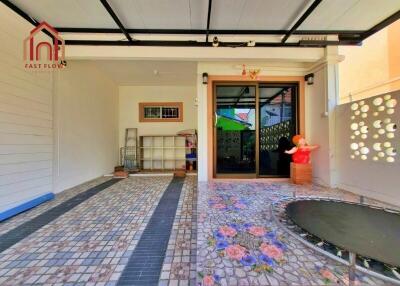 Outdoor covered space with tiled flooring and trampoline