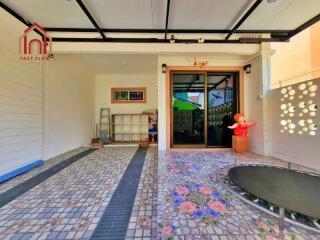 Outdoor covered space with tiled flooring and trampoline