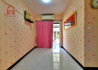 Bright hallway with pink wallpaper and curtain