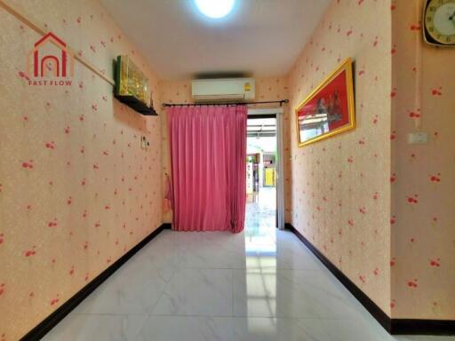 Bright hallway with pink wallpaper and curtain