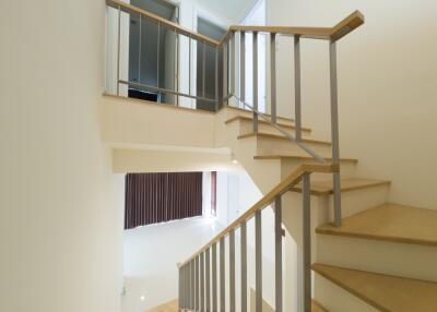 Modern stairway with wooden steps and metal railings