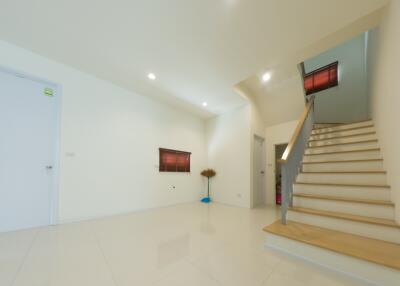 Bright and spacious main living area with staircase.