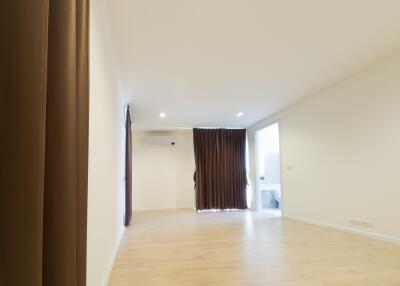 Spacious living room with wooden flooring and large windows