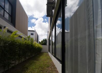 Side exterior view of a modern building with glass windows