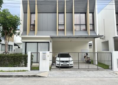 Front view of a modern two-story house with a carport