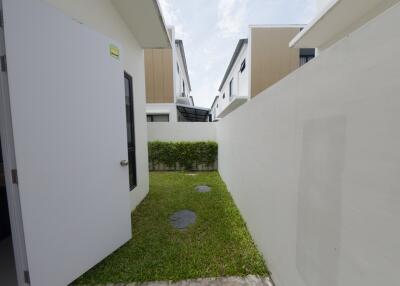 Small fenced backyard with open door