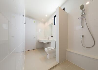 Modern bathroom with shower, toilet, and sink