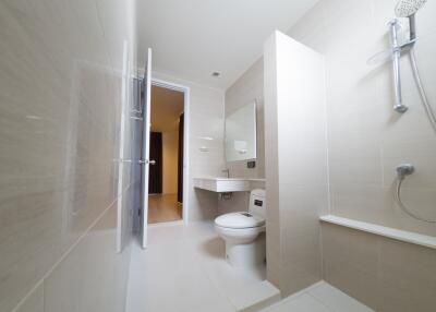 Modern bathroom with walk-in shower and wall-mounted toilet