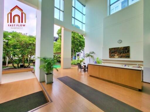 Spacious lobby area with high ceilings and natural light