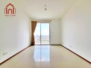 Bright empty living room with large window and city view