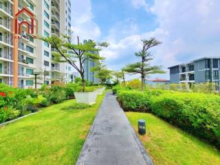 Pathway between residential buildings with greenery