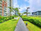 Pathway between residential buildings with greenery