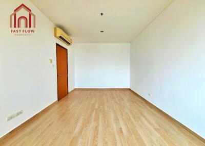 Empty bedroom with wooden flooring and air conditioning unit