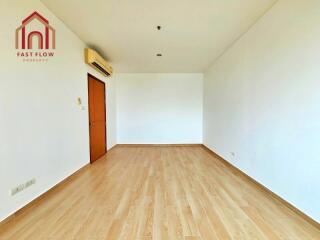 Empty bedroom with wooden flooring and air conditioning unit