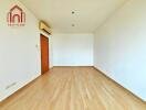 Empty bedroom with wooden flooring and air conditioning unit