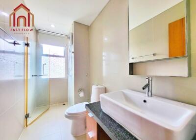 Modern bathroom with glass shower and large mirror