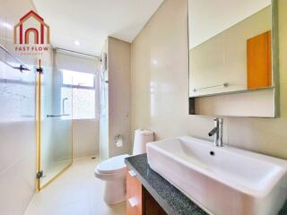 Modern bathroom with glass shower and large mirror