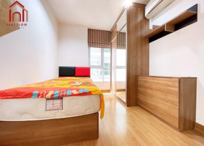 modern bedroom with wooden flooring, bed, wardrobe, and large window