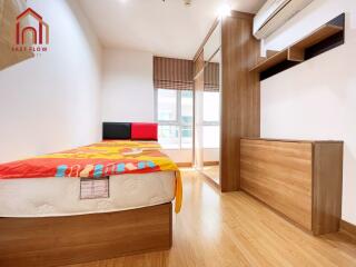 modern bedroom with wooden flooring, bed, wardrobe, and large window