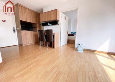 Bright living area with wooden flooring and dining space